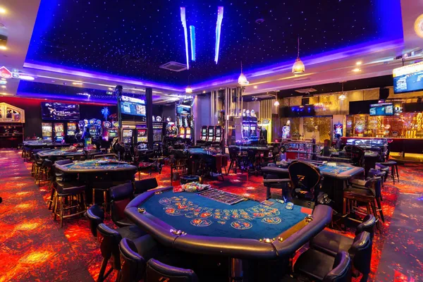 A glamorous woman holding casino chips in a neon-lit environment, representing the premium online casino atmosphere of PAGASAS.